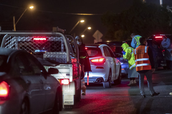 A line of cars outside the testing clinic in the Crossroads Hotel carpark.