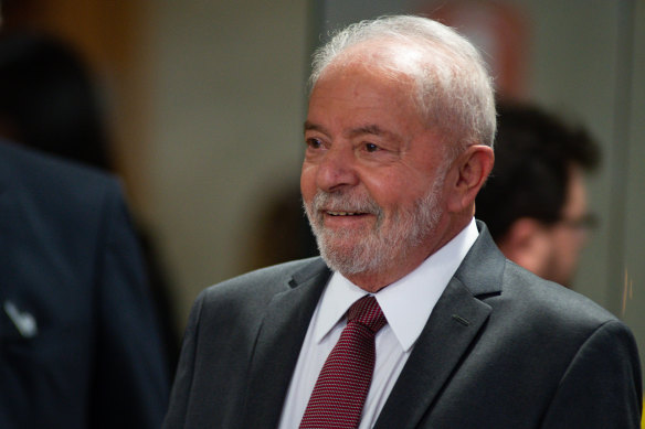 Brazilian President-elect Luiz Inácio Lula Da Silva smiles after a meeting  on Wednesday with at the electoral commission as part of the official presidential transition.