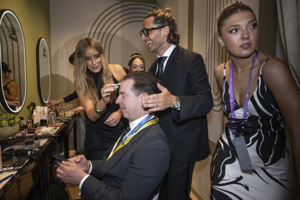 Stephen Brook gets a glow-up from make-up artist Jade Kisnorbo and hairdresser Joey Scandizzo in the Crown marquee.