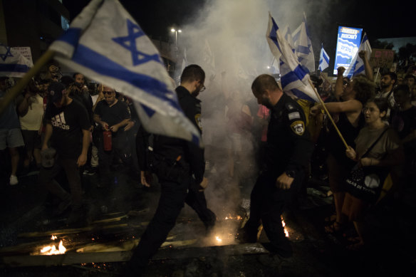 Protesters and Israeli police officers clash during a demonstration.