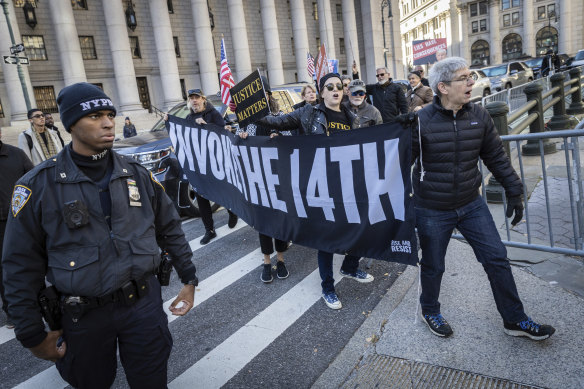 People protest against former president Donald Trump outside the New York Supreme Court. 