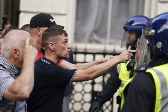 Protesters confront police officers during the “Enough is Enough” protest in Whitehall, London.