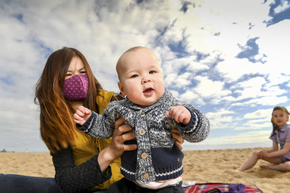 Mei Ling Tallis with her seven-month-old baby Charlie and eight-year-old daughter Kylie at Elwood Beach. 