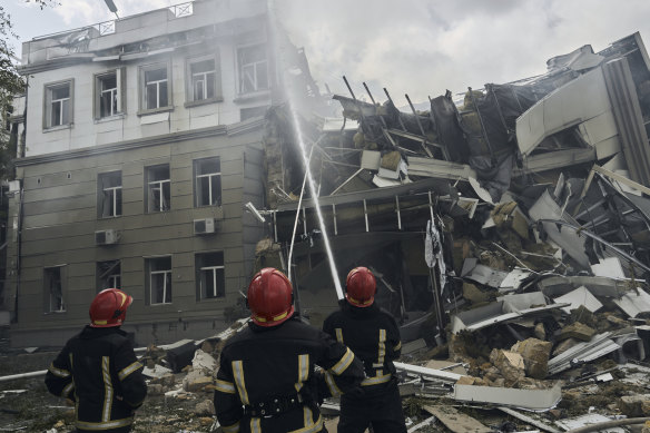 Emergency service personnel work at the site of a destroyed building after a Russian attack in Odesa, Ukraine.