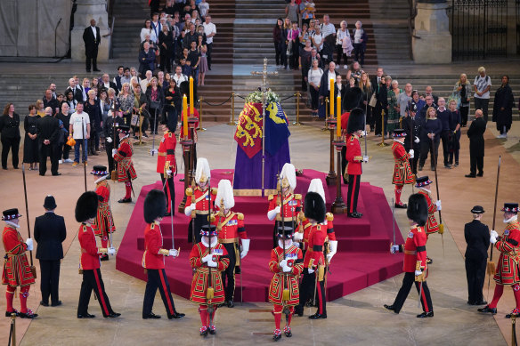 The first members of the public pay their respects as the vigil begins around the coffin of Queen Elizabeth II as it lies in state inside Westminster Hall.