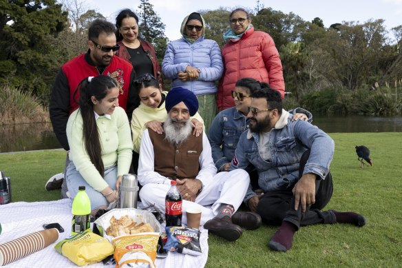 Good to see you: Kuldeep Singh, centre, and his wife Raj Kaur, standing behind him in blue, are visiting their daughter Kanwal Kaur, who is sitting behind her father.