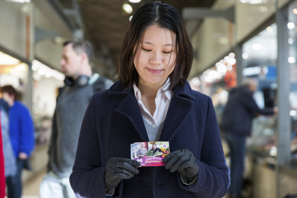 Wendy Huang, a Monash University international student, with a Queen Victoria Market food voucher. 