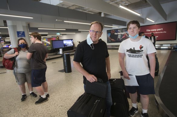 David Duncan with his son at Melbourne Airport on Friday morning. 