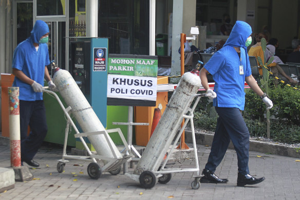 Medical workers wheel oxygen tanks at Dr Sardjito Central Hospital in Yogyakarta