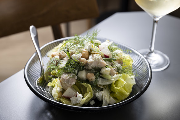 Chopped salad with chickpeas, lettuce, cucumbers, radish, buffalo curd and pepperoncini.