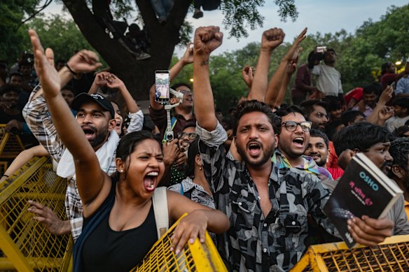 Supporters of India’s Cockroach Janta Party (CJP) celebrate following the resignation of Education Minister Dharmendra Pradhan.