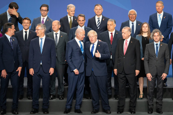 British Prime Minister Boris Johnson stands beside US President Joe Biden and other world leaders during the NATO summit.