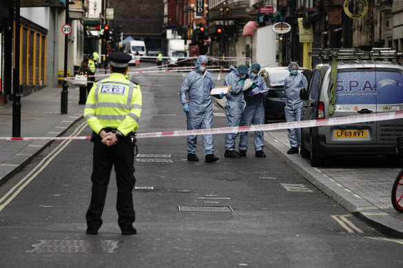 Forensics officers and police at the scene in Shaftesbury Avenue, where two male police officers were stabbed.