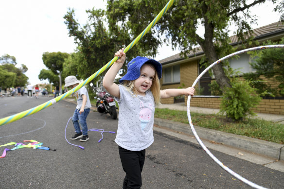 Elise Duscio, 3, has a fine old time playing with hoops. 