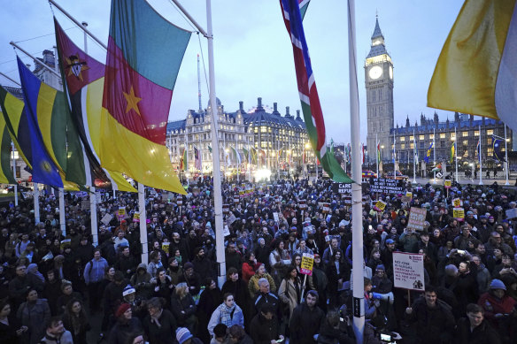 People gather in Parliament Square, London, to protest the Illegal Migration Bill during its second reading in the House of Commons, on Monday.