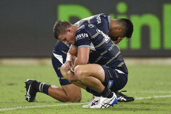 Dejected Cowboys Mitch Dunn and Murray Taulagi after their big loss in Townsville.