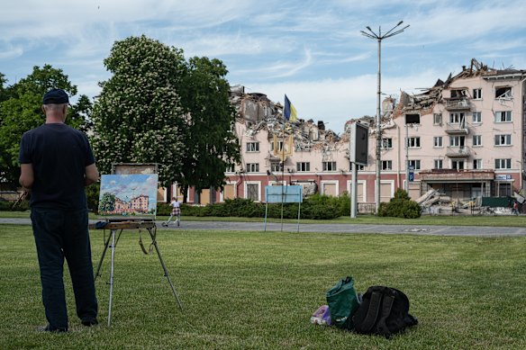 Ukrainian painter Volodymyr Natalushko paints the heavily damaged Hotel Ukraine in Chernihiv, north-east of Kyiv, an early target of Russia’s offensive after its February 24 invasion. 