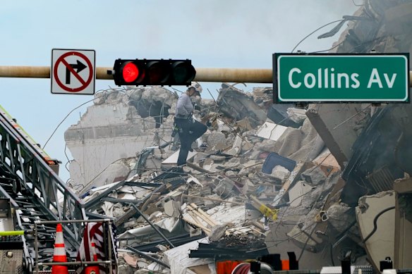 A rescue worker walks through the rubble of the 12-storey beachfront condo building.