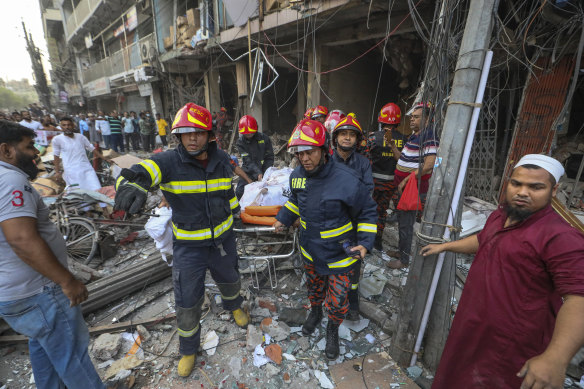 Fire officials carry a body of a victim after the explosion.