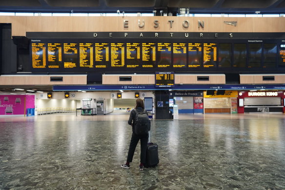 A passenger at Euston station in London looks at the departures board during a rail strike last month.