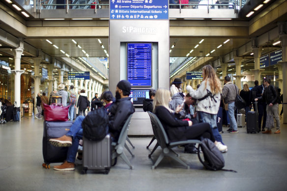 Passengers wait at St Pancras International station in London. 