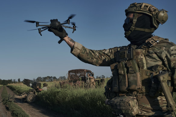 A Ukrainian soldier of the 28th brigade launches a drone at the frontline close to Bakhmut, Ukraine.