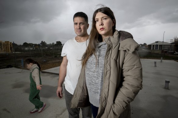 Amber-lea Drinnan and husband Dion Drinnan, standing on the concrete slab of their new home.