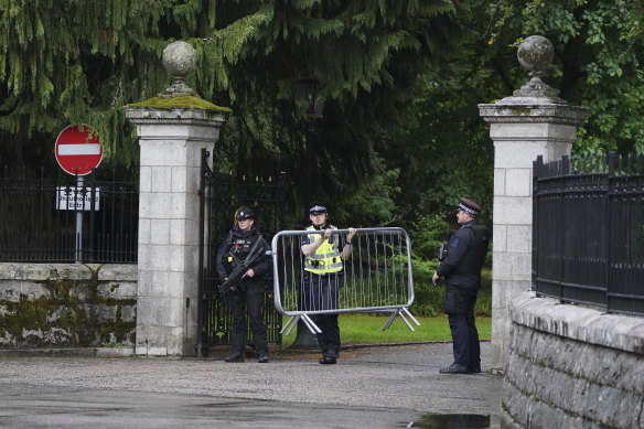 Barriers are moved into place at the entrance to Balmoral in Scotland on Thursday, where the Queen is under medical supervision.