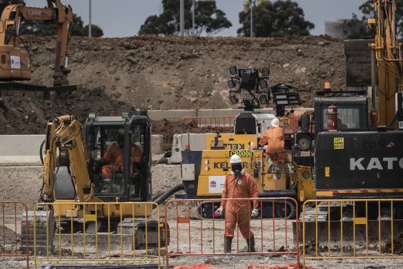 Workers in protective gear at 6 Grand Avenue Camellia, which is a heavily contaminated site that will become the main stabling yard for Parramatta light rail.