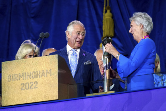 Prince Charles and Dame Louise Martin enjoy a moment at the opening ceremony.