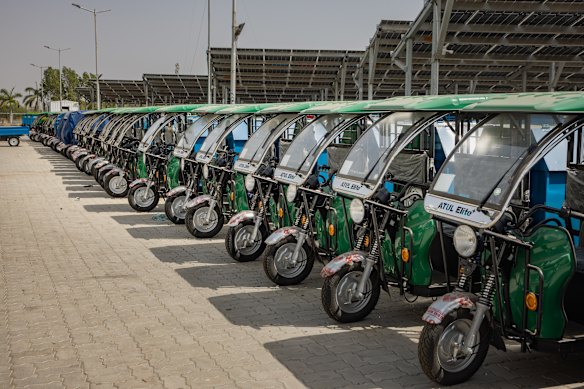 Rickshaws parked outside an Ahmedabad factory are ready for export.