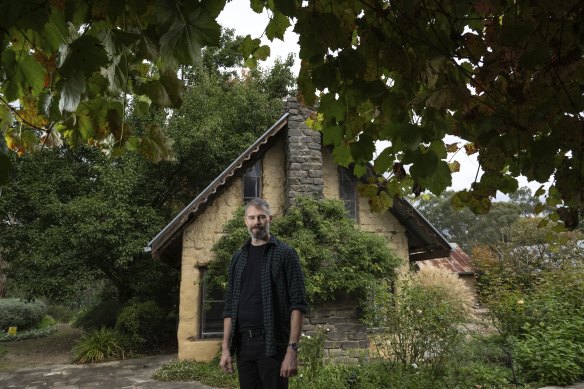 Magnus Irvine in front of a mud-brick house that will be retained as part of the Brougham St Collective townhouse development. 