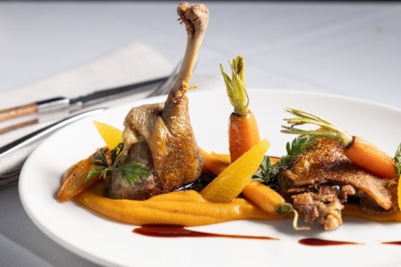 Duck a l'orange with baby carrots.
