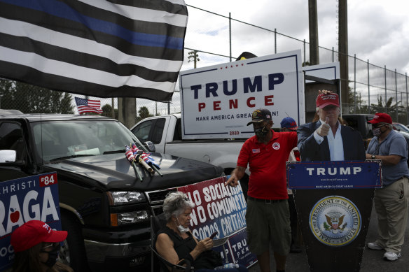 Trump supporters rally outside an early voting booth in Miami, Florida. 