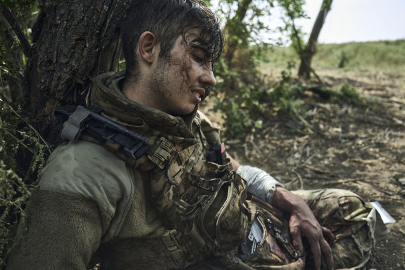A wounded soldier of Ukraine’s 3rd Separate Assault Brigade, call sign Polumya (Flame), 19, waits for evacuation near Bakhmut, Ukraine, on Monday.