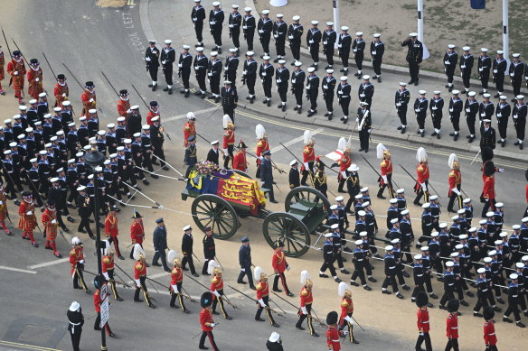 The State Gun Carriage carrying the coffin of Queen Elizabeth II, draped in the Royal Standard with the Imperial State Crown and the Sovereign’s orb and sceptre, leaves Westminster Abbey, London, on Monday.