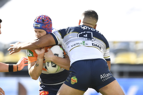 Kalyn Ponga, who had an unhappy homecoming to Townsville, is collected by Esan Marsters.
