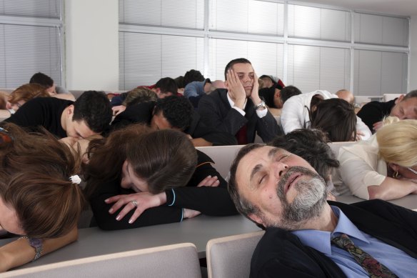 The people in this generic Image are so tired they even fell asleep during a board meeting.