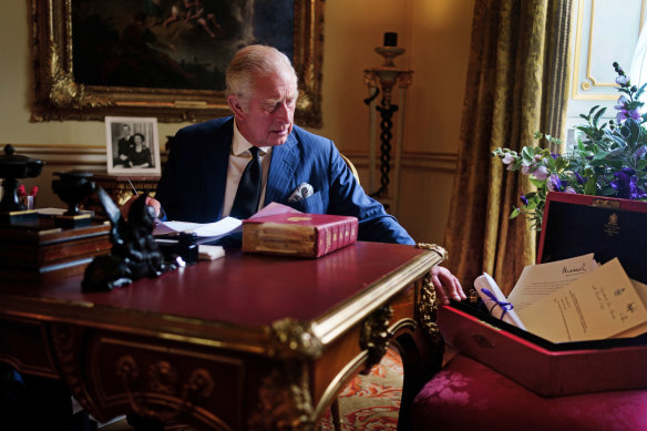 King Charles III carries out official government duties from his red box in the Eighteenth Century Room at Buckingham Palace, London.