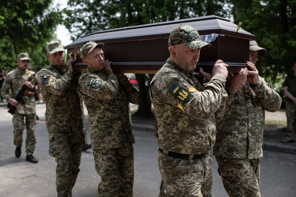 Ukrainian soldiers bury a comrade in Sumy. Everyone is the town knows someone who has enlisted and is fighting.