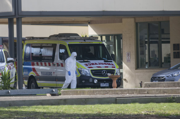 An ambulance at St Basil's Homes for the Aged in Fawkner, where an outbreak has infected 78 people.

