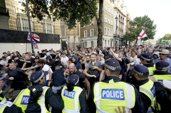 Police officers clash with protesters during an “Enough is Enough” protest rally in London.