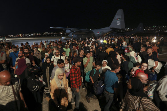 Jordanians evacuated from Sudan arrive at a military airport in Amman, Jordan, on Monday.