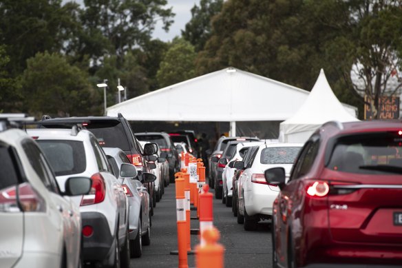 Drivers wait for COVID-19 testing  in Cheltenham.