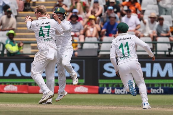 South Africa’s Simon Harmer celebrates after Josh Inglis was run out.