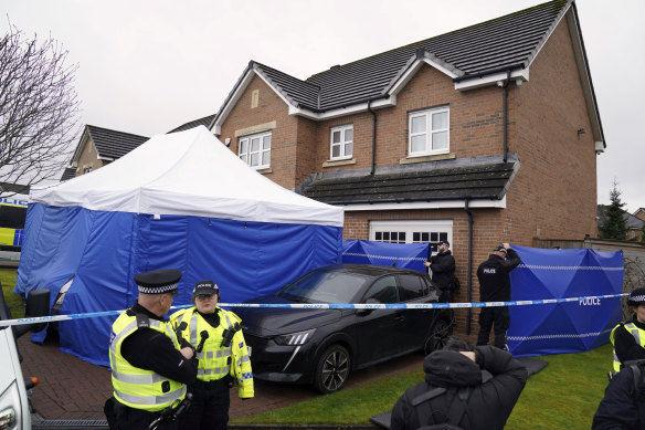 Scotland police officers outside the home of former chief executive of the Scottish National Party Peter Murrell.
