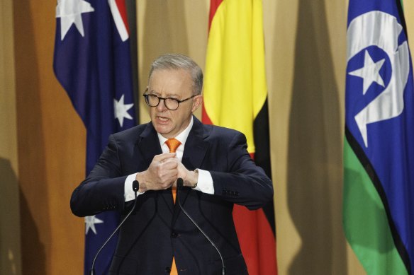 Prime Minister Anthony Albanese speaks in front of Australian, Aboriginal and Torres Strait Islander flags at a ceremony to mark the 47th term of parliament in 2022.