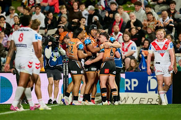 The Tigers celebrate an Adam Doueihi try.