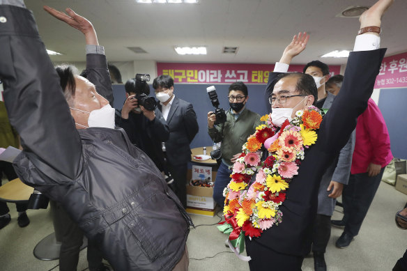 Thae Yong Ho, right, former North Korean diplomat reacts with a supporter after he was certain to secure victory in the parliamentary election in Seoul, South Korea on Thursday.