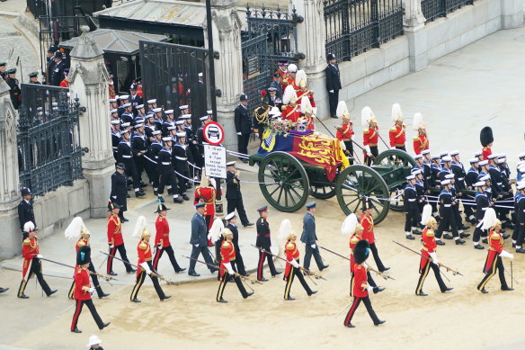 The Queen’s coffin is carried out of the Abbey for the procession to Wellington Arch.